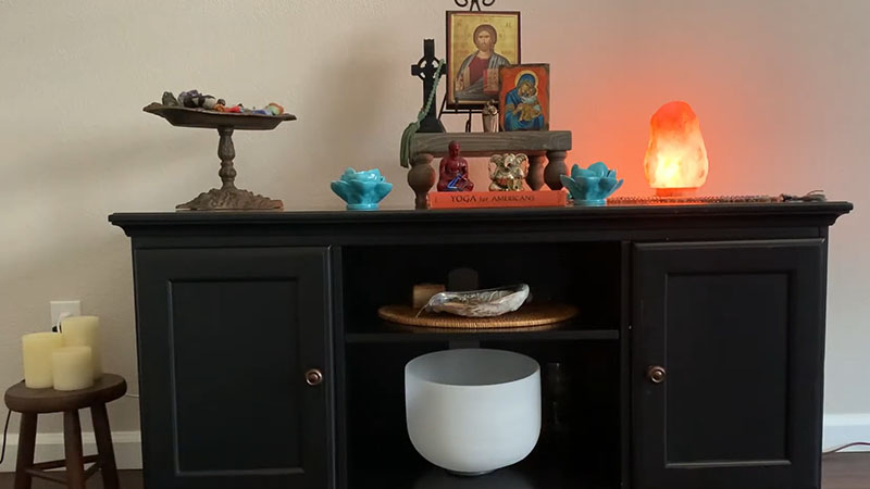 Altar with various prayer beads, candles, and buddah