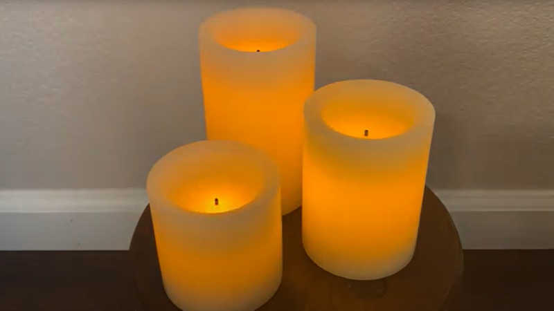 Three pillar candles burning